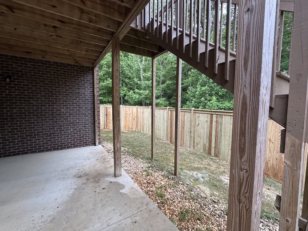 Wood privacy fence installation under a residential deck in Birmingham, AL